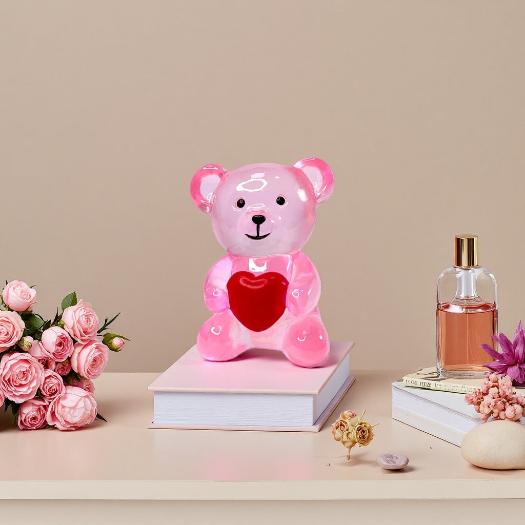 pink resin bear ornament on table